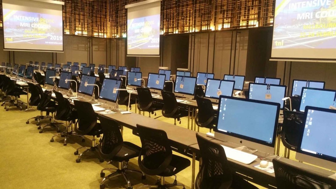 Rows of identically configured workstations set up by Hire Intelligence for a large exam event