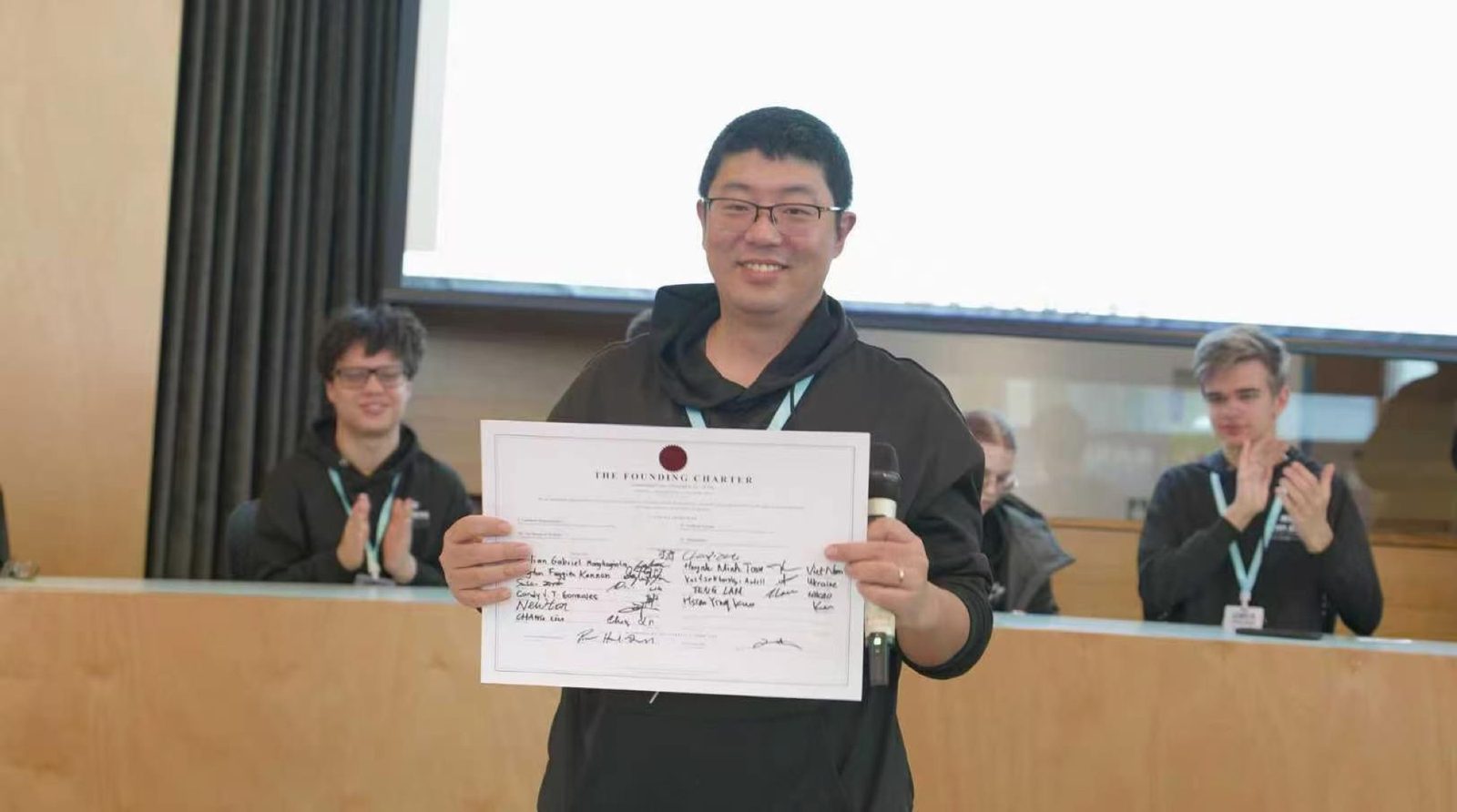 ICOA Founder Charlie Zhu presents the signed Founding Charter of the International Cyber Olympiad in AI